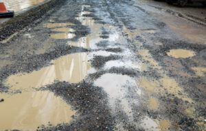 Loose gravel driveway with pot holes 